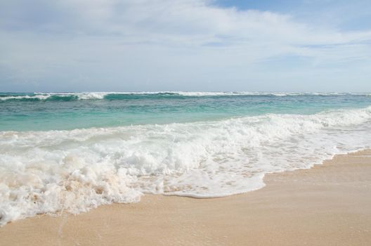 Turquoise ocean and sandy beach of the island of Bali, Indonesia.