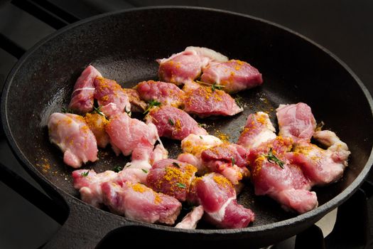 Cooking beef stew in a cast iron skillet on the cooker. Stock image.