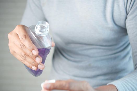 mouthwash liquid flowing into a cap , close up