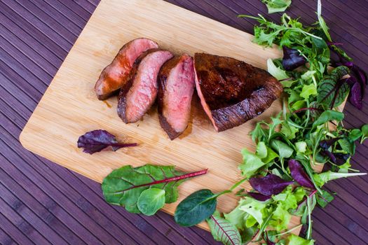 Beef grilled with blood on the kitchen blackboard. Stock image.