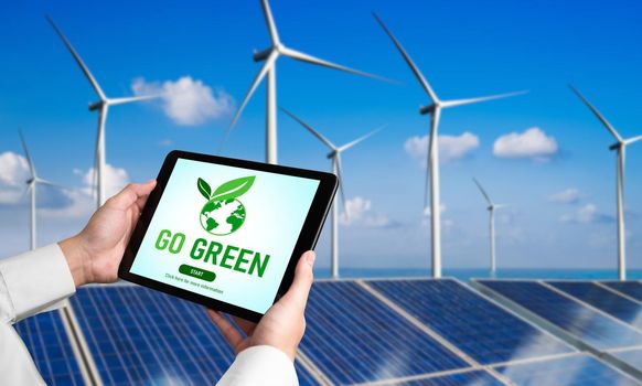 Green business transformation for environment saving and ESG business concept. Businessman using tablet to set corporate goal toward environmental friendly management and alternative clean energy use.