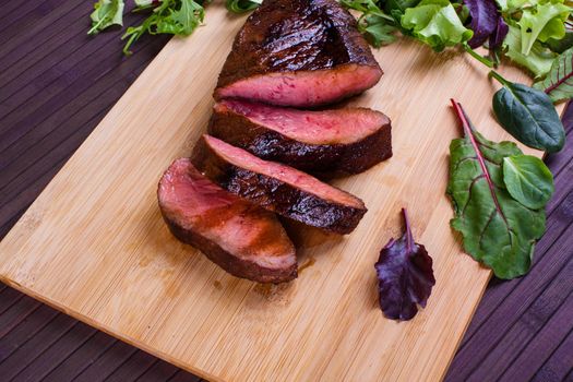 Beef grilled with blood on the kitchen blackboard. Stock image.