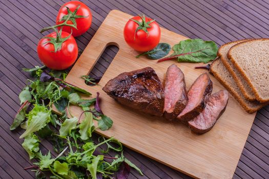 Beef grilled with blood on the kitchen blackboard. Stock image.