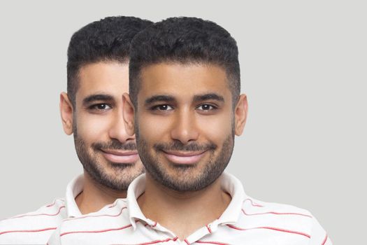 Closeup portrait of young brunette bearded man with different facial skin tone, darker and lighter, looking and smiling. before and after, sunbath, treatment and solarium concept. indoor studio shot.