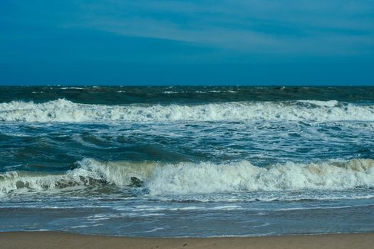 Ocean storm waves dramatically crashing splashing. Sky horizon line. Sea water edge, nature front view marine wallpaper. Bad weather cloudy overcast. Dark green turquoise blue bright vivid contrast.