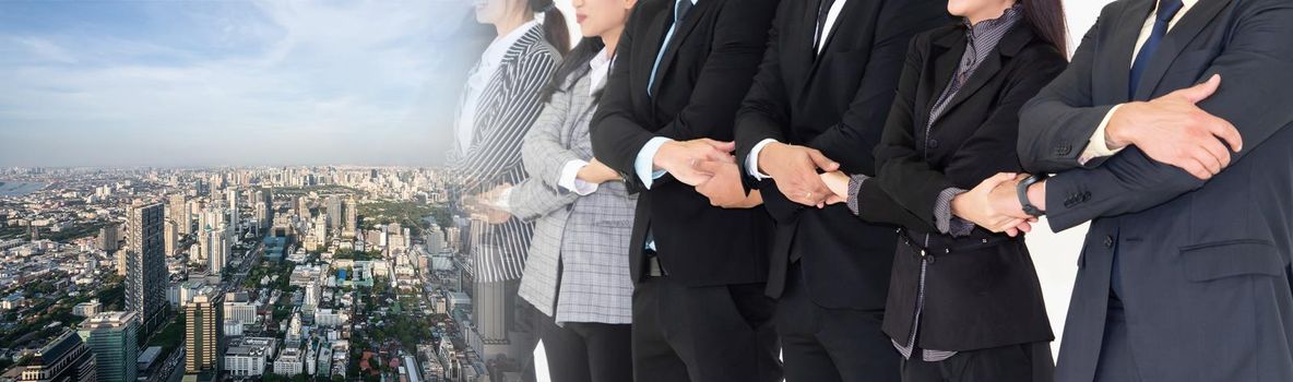 Successful business people standing together showing strong relationship of worker community. A team of businessman and businesswoman expressing a strong group teamwork at office broaden view