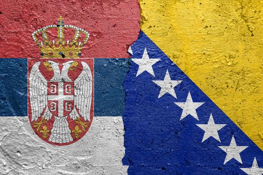 Serbia and Bosnia and Hercegovina flags  - Cracked concrete wall painted with a Serbian flag on the left and a Bosnian flag on the right