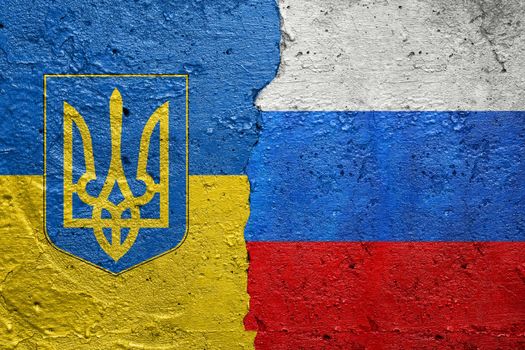 Ukraine and Russian Federation Russia flag- Cracked concrete wall painted with a Ukrainian flag on the left and a Russian flag on the right