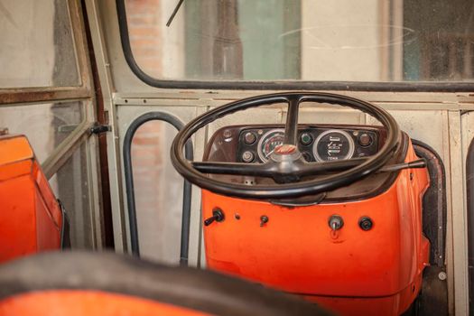 Dashboard and steering wheel of the old tractor