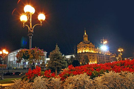 Night Kiev with blooming flowers and a view of the main Khreschatyk street. Street decoration. Illumination in evening Kyiv before the war. Beautiful European city. Ukrainian capital
