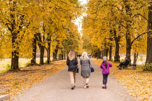 Happy family playing in autumn park.