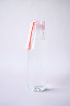 fresh drinking water in a pink color bottle .