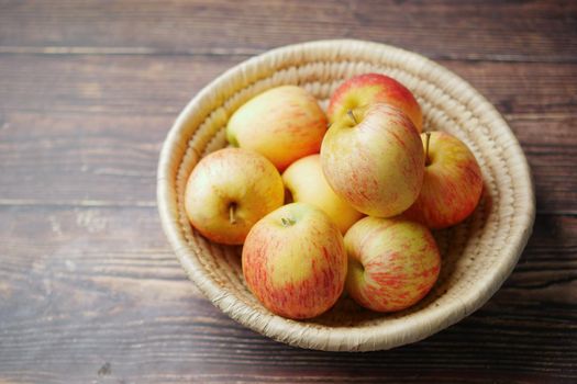 Close up of fresh apple in a bowl on wooden table.
