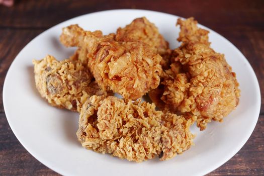 Crispy fried chicken on a plate top view