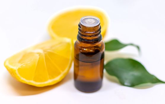 Lemon essential oil on a white isolated background. Selective focus. Food.