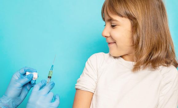The child is injected into the arm. Selective focus.