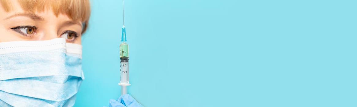 Doctor with a syringe in his hands. Selective focus.