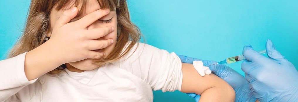 The child is injected into the arm. Selective focus.