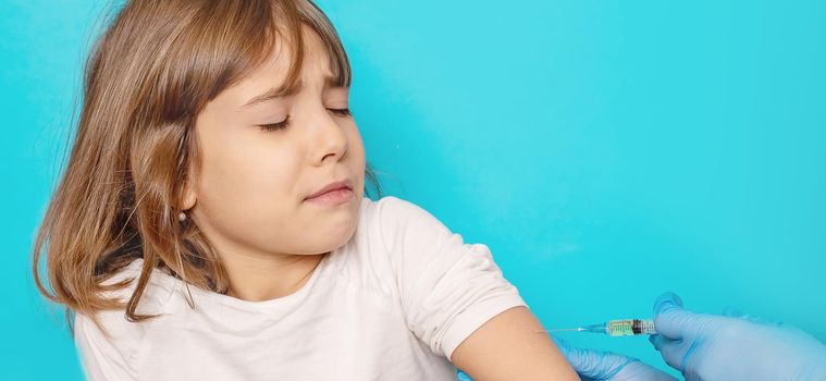 The child is injected into the arm. Selective focus.