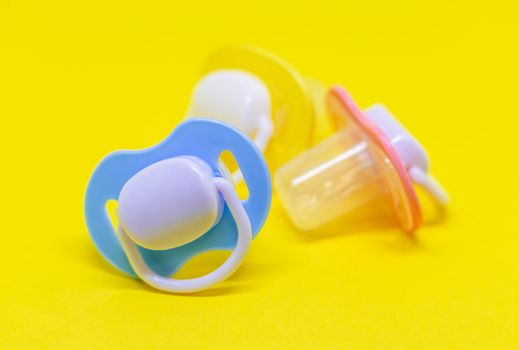 Dummy pacifiers for newborns in different colors. Selective focus. baby.