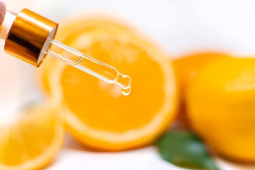 Orange essential oil on a white isolated background. Selective focus. food.