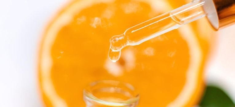 Orange essential oil on a white isolated background. Selective focus. food.