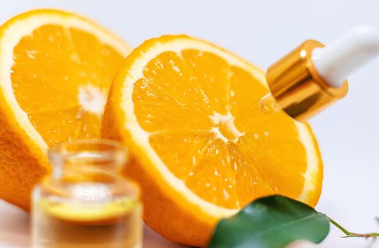 Orange essential oil on a white isolated background. Selective focus. food.