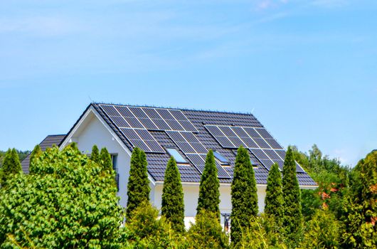 Historic farm house with modern solar panels on roof and wall High quality photo