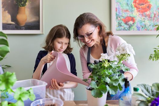 Mother and daughter kid together take care of indoor plants in pots, girl watering flower from watering can. Hobbies and leisure, care, family, houseplant, home potted friends concept