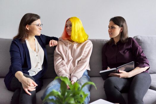 Woman social worker talking to mother and daughter teenage girl. Professional advice, help, support. Psychology, therapy, adolescence, family, mental health conceptt