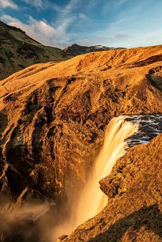 Beautiful Skogafoss waterfall during the summer season seen from the top, Iceland