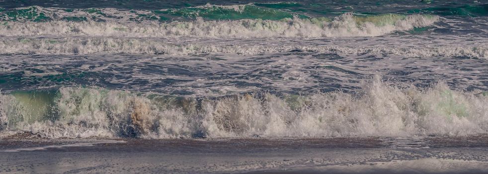 Ocean storm waves dramatically crashing splashing. Sky horizon line. Sea water edge, nature front view marine wallpaper, design. Bad weather cloudy overcast. Dark green turquoise blue tone pale matte.