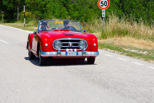 URBINO, ITALY - JUN 16 - 2022 : NASH HEALEY ROADSTER 1953 on an old racing car in rally Mille Miglia 2022 the famous italian historical race (1927-1957