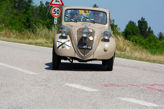 URBINO, ITALY - JUN 16 - 2022 : FIAT 500 B TOPOLINO 1948 on an old racing car in rally Mille Miglia 2022 the famous italian historical race (1927-1957