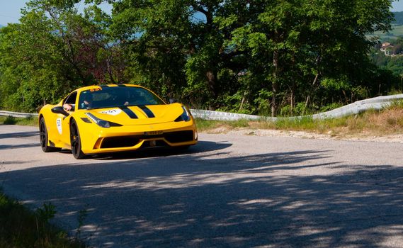 URBINO, ITALY - JUN 16 - 2022 : FERRARI TRIBUTE Ferrari 458 Speciale IN an old racing car in rally Mille Miglia 2022