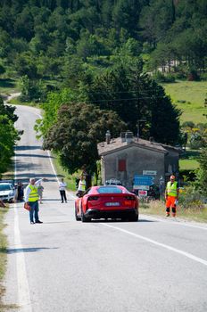 URBINO, ITALY - JUN 16 - 2022 : FERRARI TRIBUTE Ferrari 812 Superfast IN an old racing car in rally Mille Miglia 2022