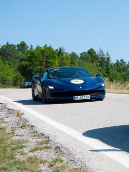 URBINO, ITALY - JUN 16 - 2022 : FERRARI TRIBUTE FERRARI SF90 STRADALE IN an old racing car in rally Mille Miglia 2022