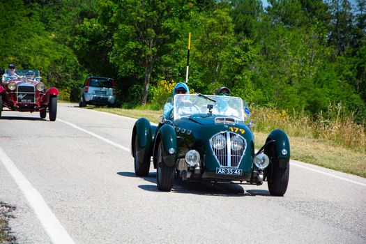 URBINO, ITALY - JUN 16 - 2022 : HEALEY 2400 SILVERSTONE (D-TYPE) 1950 on an old racing car in rally Mille Miglia 2022 the famous italian historical race (1927-1957