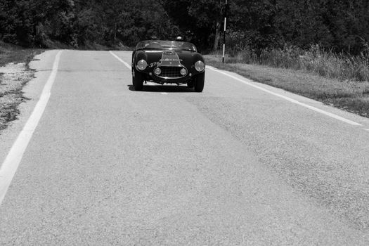 URBINO, ITALY - JUN 16 - 2022 : FERRARI 166 MM SPIDER VIGNALE 1953 on an old racing car in rally Mille Miglia 2022 the famous italian historical race (1927-1957