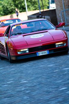 URBINO, ITALY - JUN 16 - 2022 : FERRARI TRIBUTE Ferrari 360 stradale IN an old racing car in rally Mille Miglia 2022