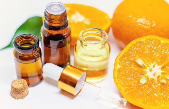 Orange essential oil on a white isolated background. Selective focus. food.