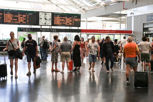 Alicante, Spain- June 24, 2022:Passengers walking through the train station of Alicante with suitcases