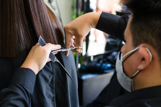 Young man and woman hairdressers in beauty salon