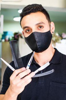 Barber Shop. The hairdresser has a scissors and a comb, with a mask for the pandemic