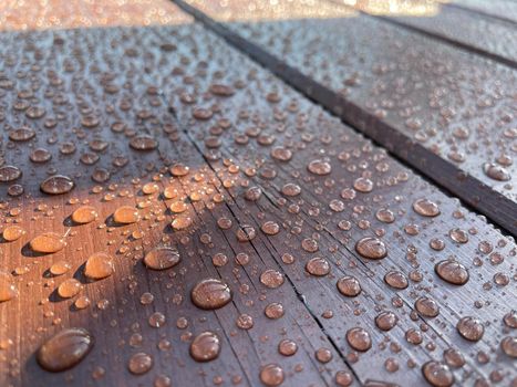 Lots of water drops on dark wood background