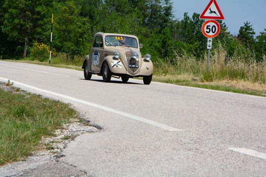 URBINO, ITALY - JUN 16 - 2022 : FIAT 500 B TOPOLINO 1948 on an old racing car in rally Mille Miglia 2022 the famous italian historical race (1927-1957