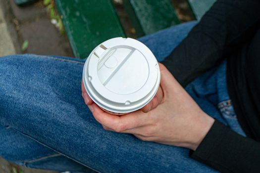 Coffee Business Concept-Female barista making coffee and serving a paper cup of hot coffee in street. High quality photo