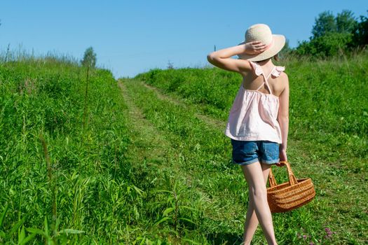 Little cute girl in the hat close-up portrait outdoors. The concept of a happy childhood. High quality photo