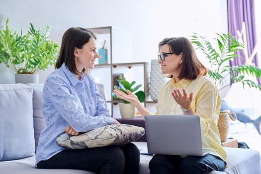 Young woman patient on individual therapy in psychologists office. Mature female concellor listening taking notes talking. Psychology, psychiatry, treatment, mental health concept