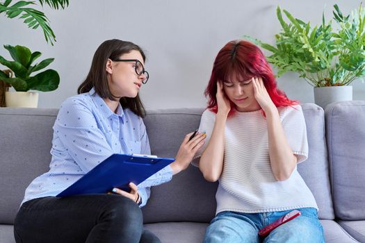 Professional psychologist working with teenage student girl. Female patient stressed out, individual therapy, help to teenager. Mental health, counseling, adolescence, psychology, psychiatry concept